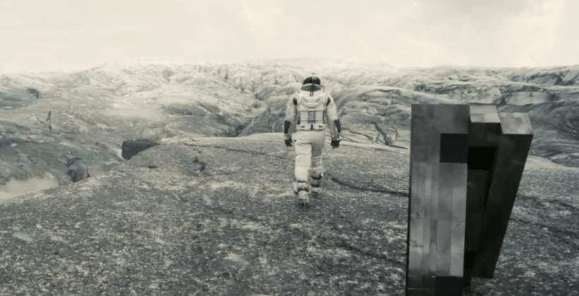 A still from the film "Interstellar." Astronaut and robot working together